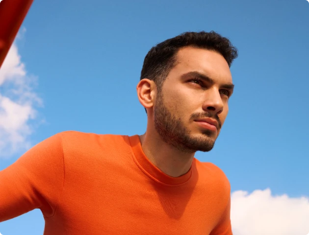 Active young man enjoying a clear, sunny day, feeling refreshed and free from allergy symptoms.