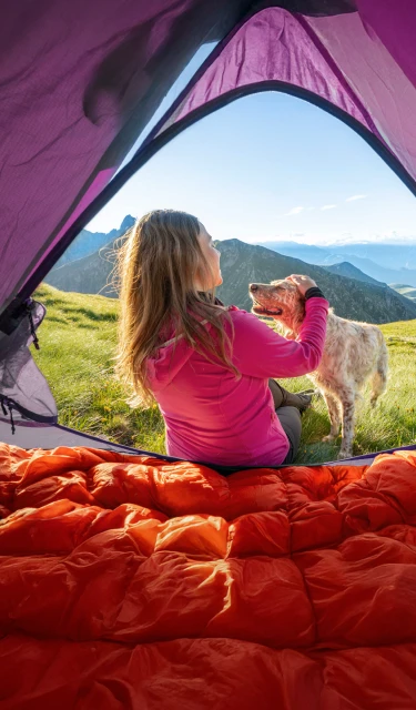 Woman enjoying the outdoors with her dog, thanks to effective allergy relief.