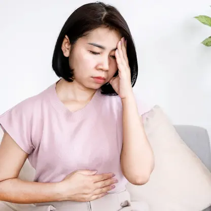 a woman showing digestive discomfort and stress-related gut health issue